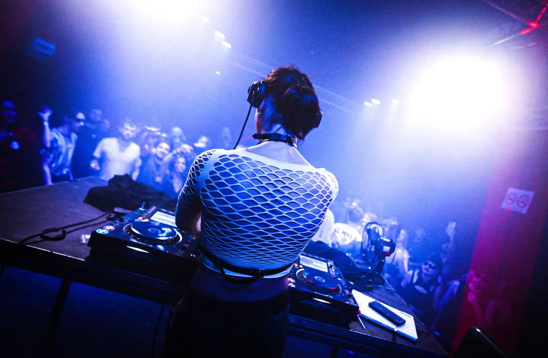 DJ playing to the crowd from the booth at a CAVE 28 night